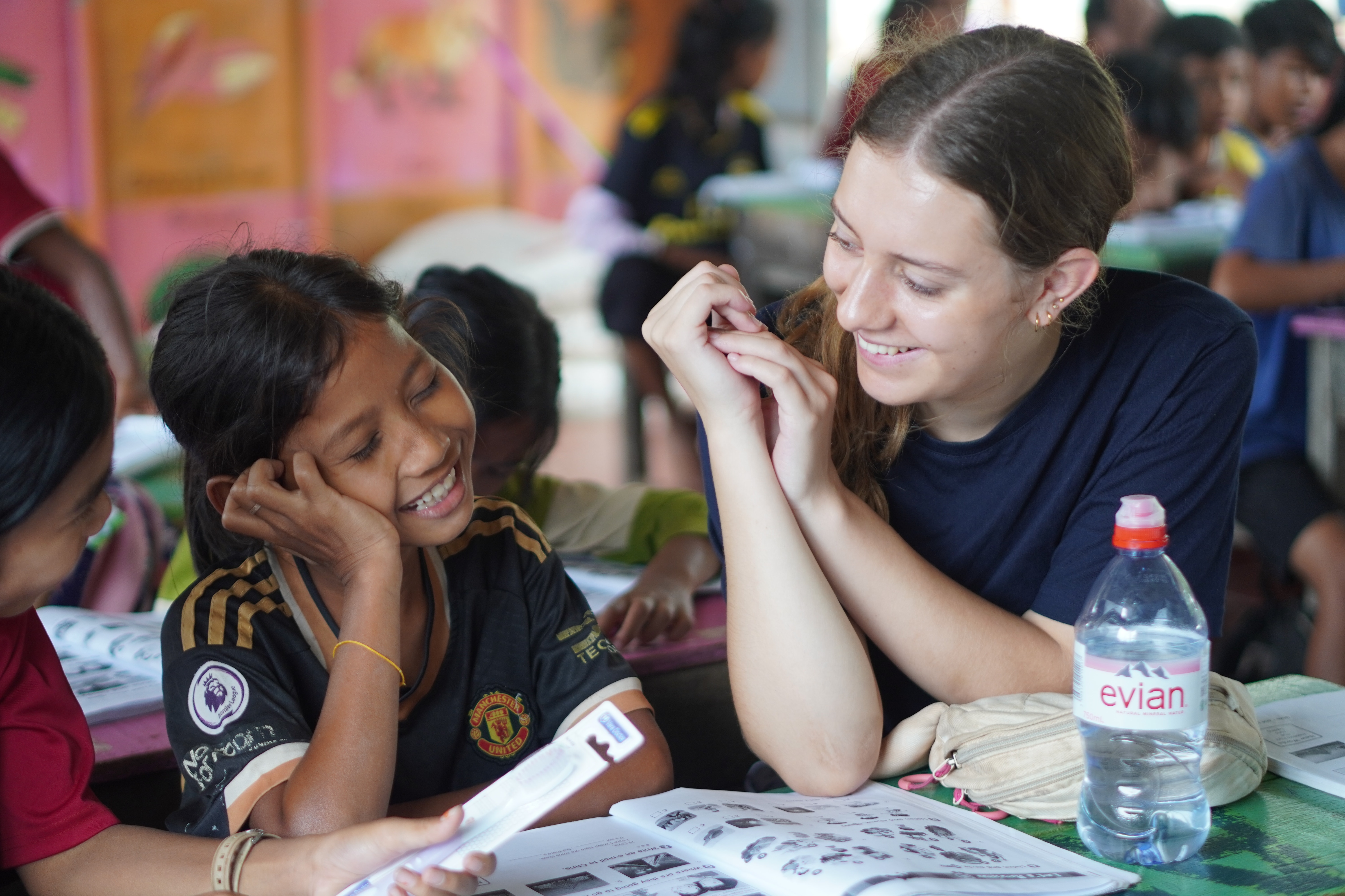 Volunteer supporting children at the school