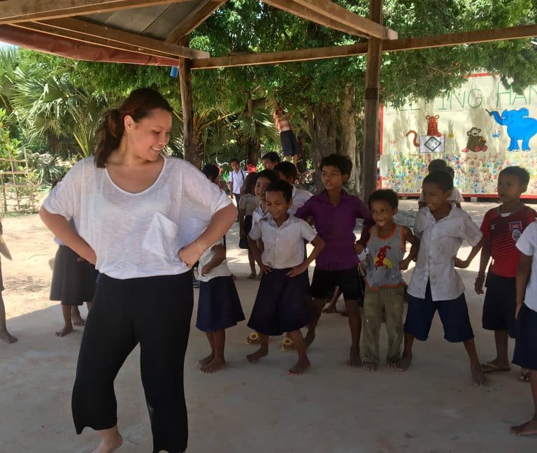 Volunteer leading a dance activity with students in rural Cambodia