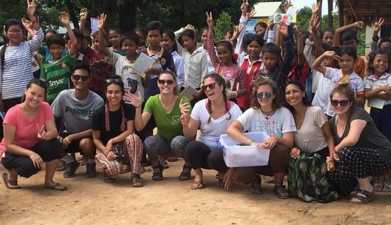 University volunteer group with students at a rural school near Siem Reap