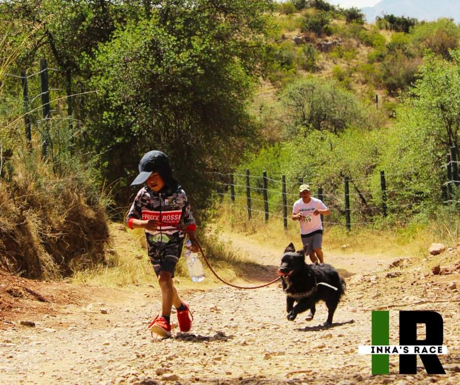 Child running with dog during race Child running with dog during race"