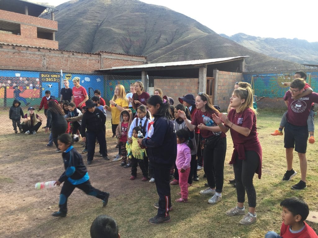 Durham University students playing games with children at Picaflor House