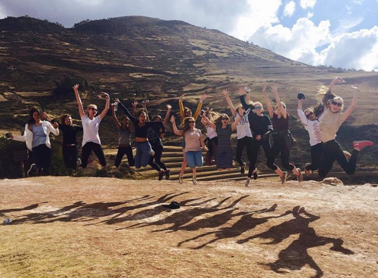 A volunteer group jumping for joy in the Andes near Picaflor House