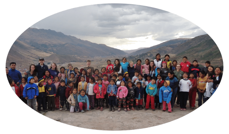 volunteers helping children at education project cusco peru