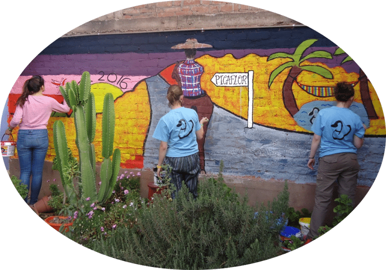 volunteers painting mural at kids community project cusco peru