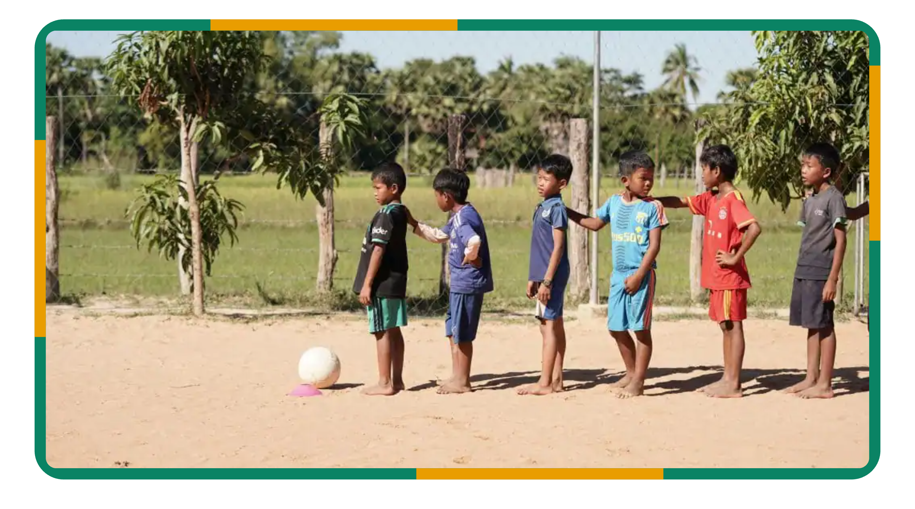 Children lining up for a football drill during a sports coaching session in Siem Reap Children lining up for a football drill during a sports coaching session in Siem Reap