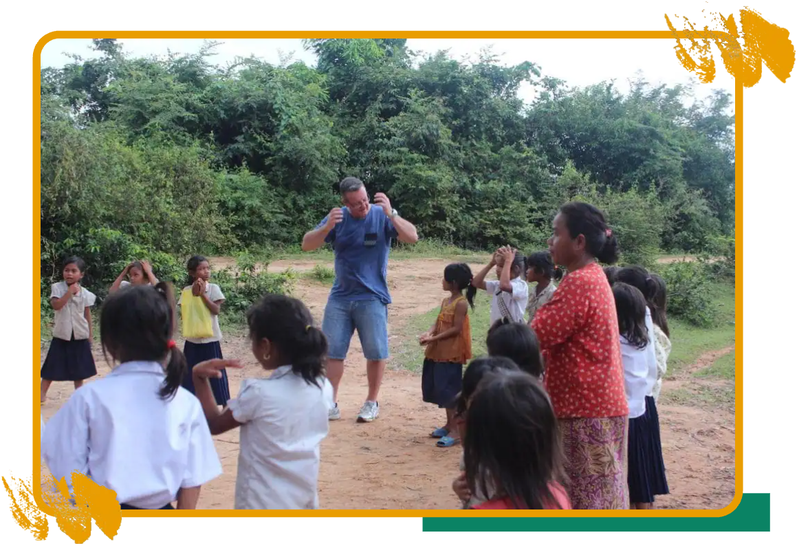 A sports volunteer coaching children in Cambodia A sports volunteer coaching children in Cambodia