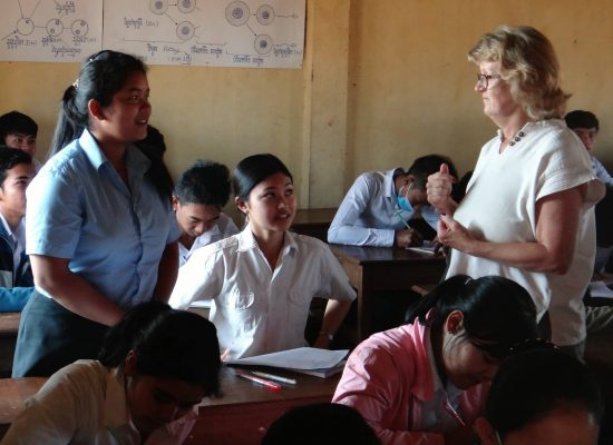 Volunteer with local students Cambodia"
