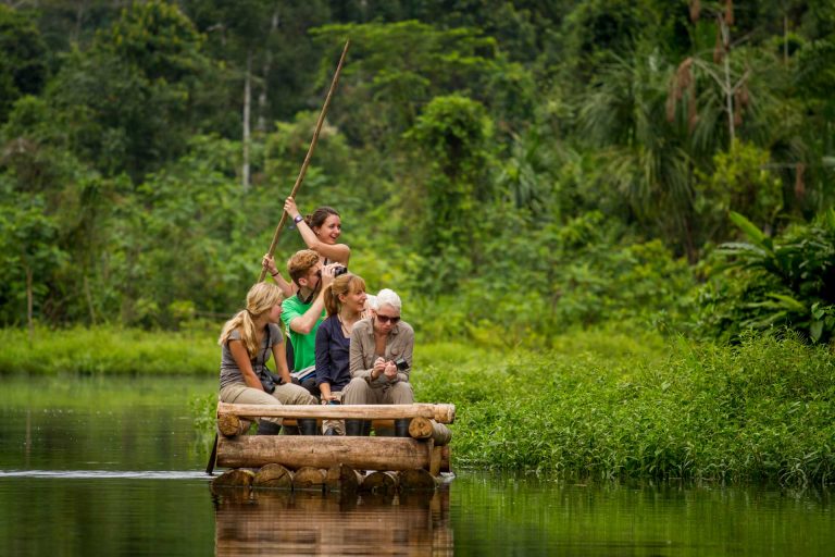 Volunteers in the Manu rainforest Volunteers on a wooden raft on a rainforest lake in Manu, Peru