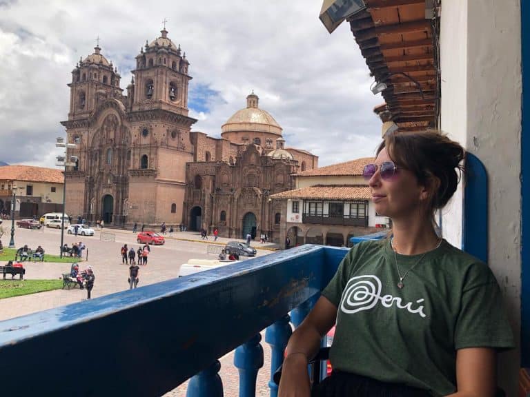 Volunteer on a balcony overlooking the Plaza de Armas in Cusco