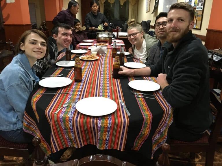 Volunteers sharing dinner at the Volunteer House in Cusco