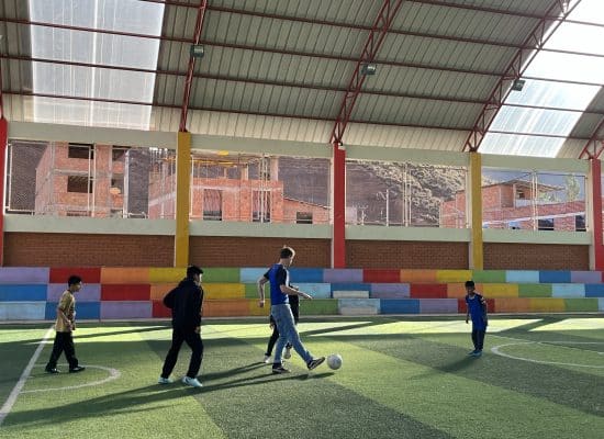 Florian playing football with the children"