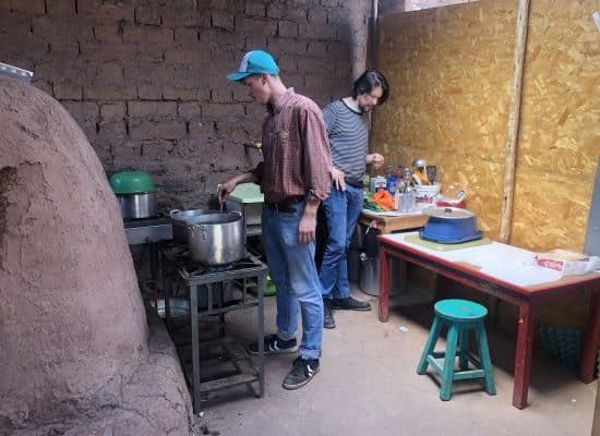 Florian and Picaflor Project Manager Oskar cooking food for the children"