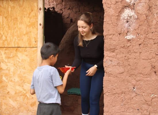 Volunteer giving lunch to the children"