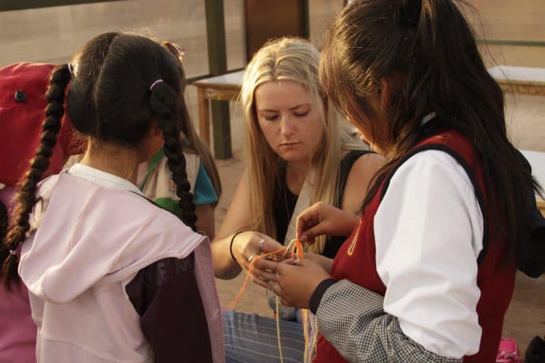 Volunteer making crafts with children in Cusco