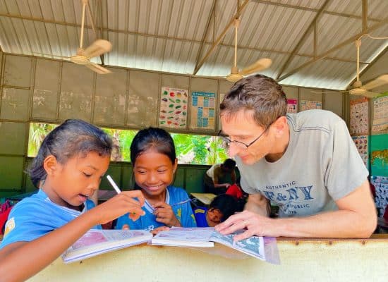 Volunteer helping the children in Siem Reap"