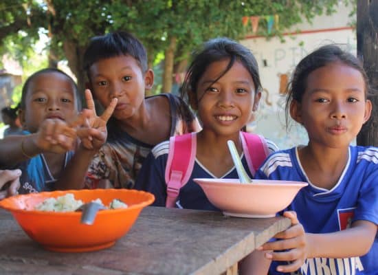 Children eating breakfast together at school in Cambodia"