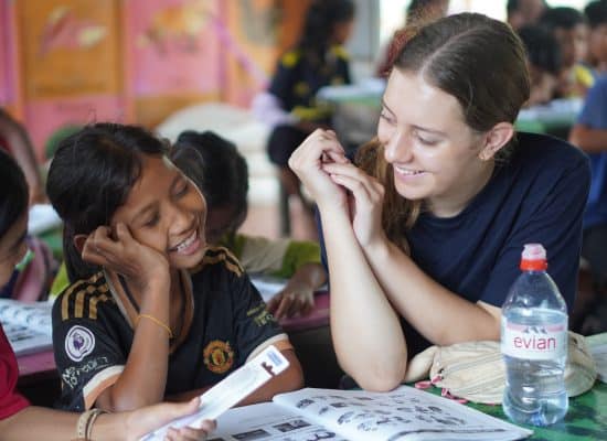 Volunteer supporting children at the school"