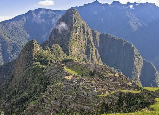 The ancient ruins of Machu Picchu with Huayna Picchu mountain behind"