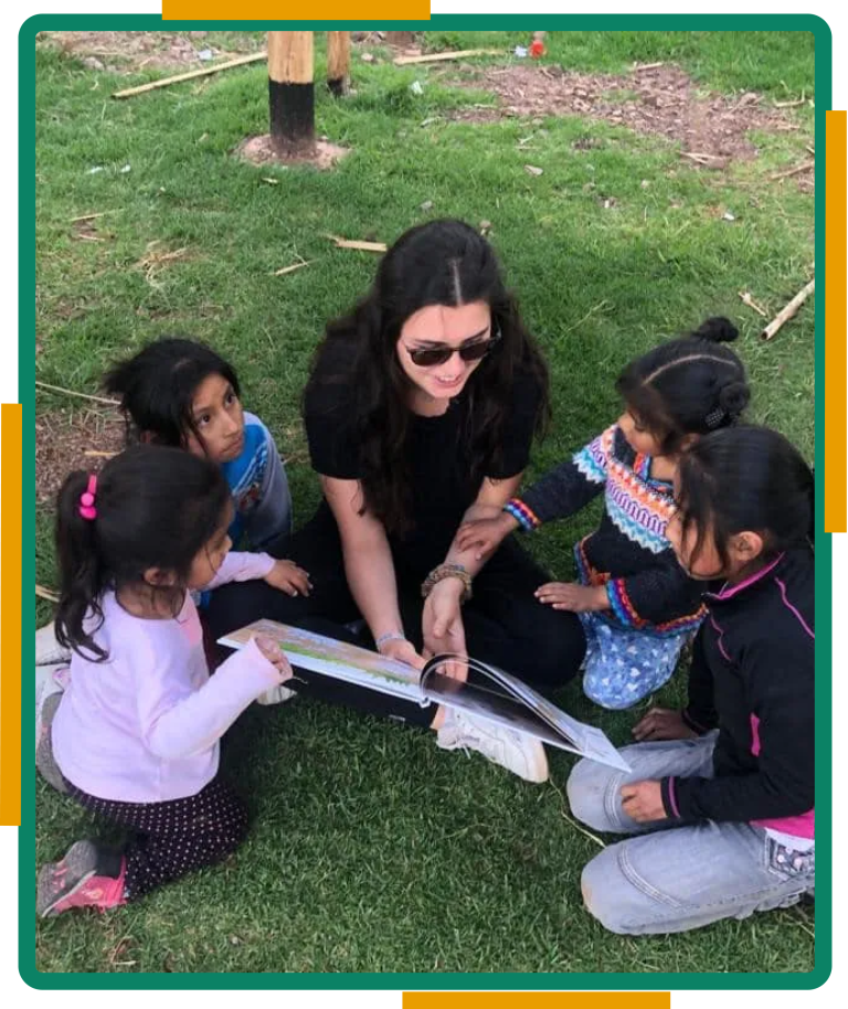 Volunteer helping children with homework outdoors