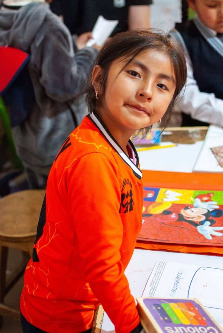 Girl smiling in class at Picaflor House
