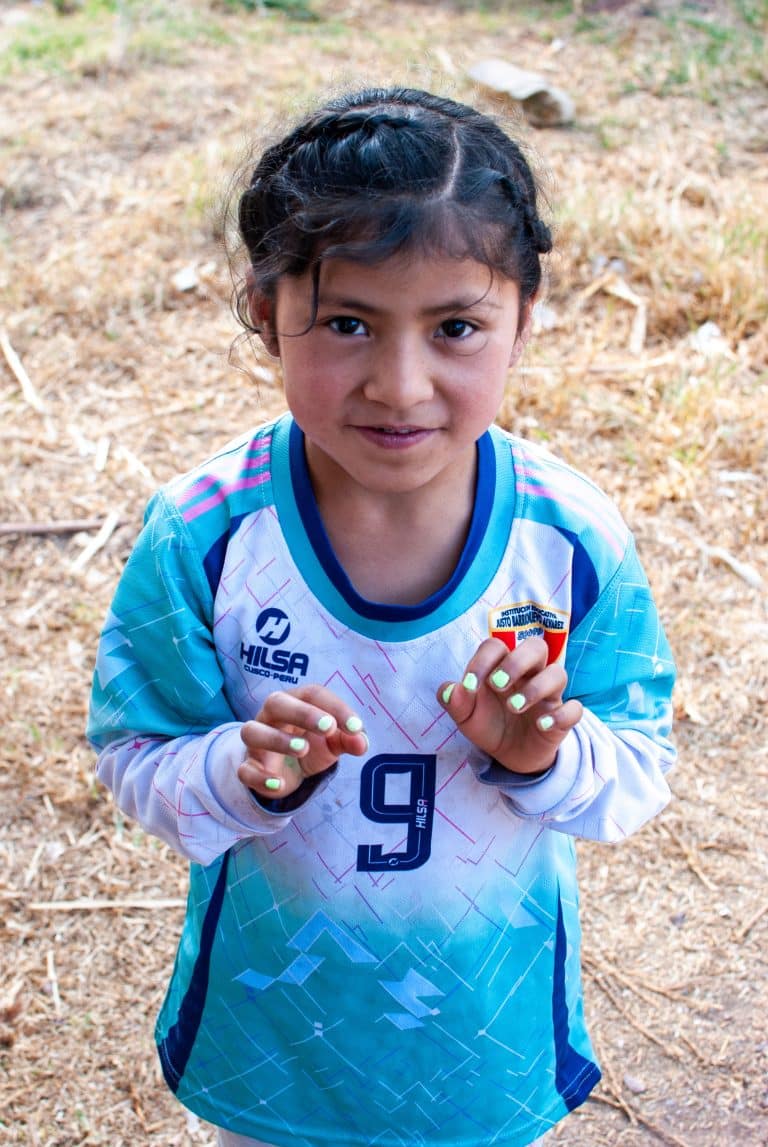 Smiling girl in a football shirt at Picaflor House