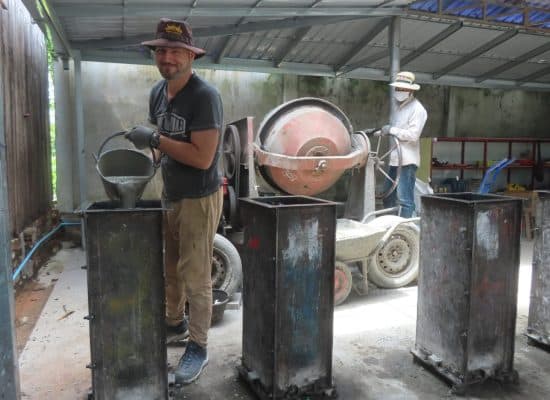 Volunteer building bio-sand water filters in Cambodia"