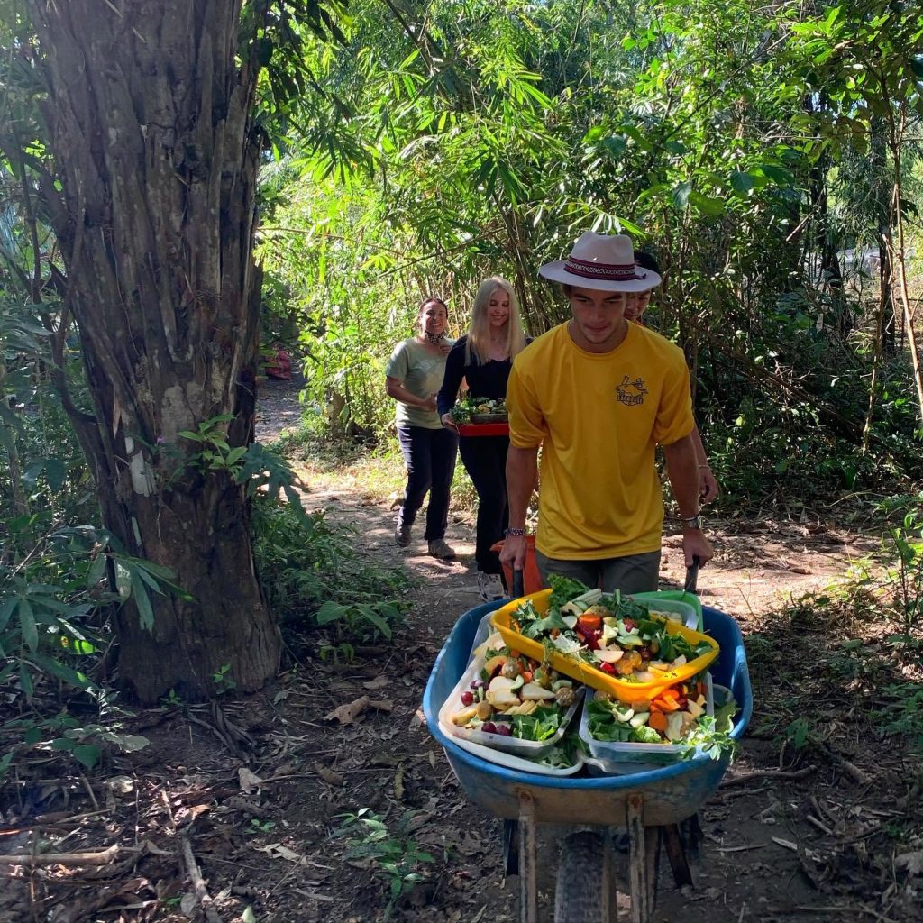 Volunteers taking prepared fruit and vegetables to the animals at the wildlife sanctuary
