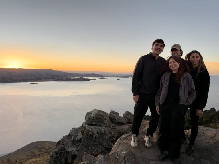 Four Globalteer volunteers at sunset above Lake Titicaca