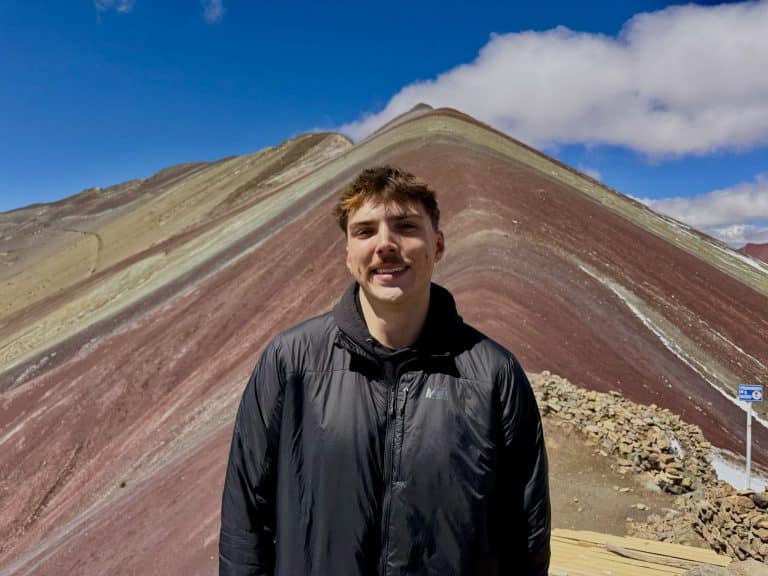 Globalteer volunteer smiling in front of Rainbow Mountain (Vinicunca) near Cusco