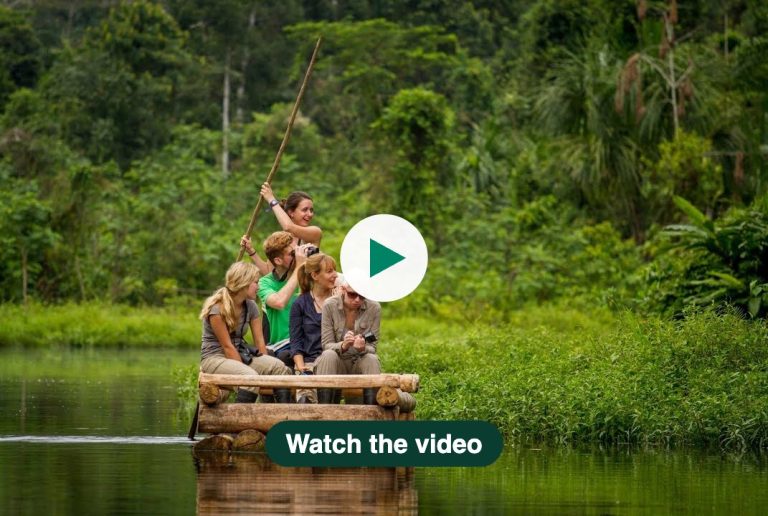 Volunteers on a wooden raft in the Peruvian Amazon. Click to watch the video